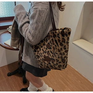 Chic leopard print plush tote bag styled with cozy winter knitwear and warm decor