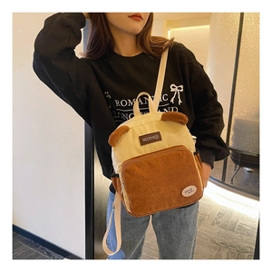 Detail of corduroy mini backpack with bear ears design and contrast color paneling
