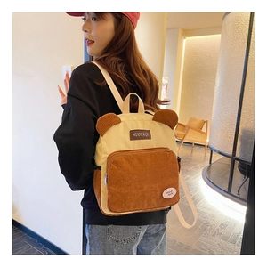 Detail showing plush corduroy texture and cute bear ears on this beige fashion backpack
