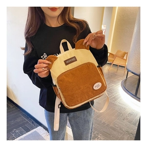 Detailed view of the cute bear ears and corduroy texture on the fashion backpack