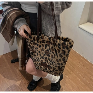 Detailed close-up of the plush leopard print faux fur tote bag with brown leather strap