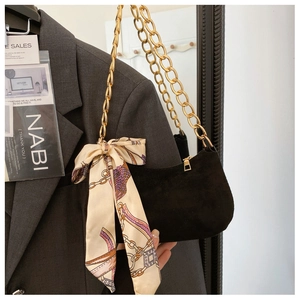 Minimalist black PU underarm bag with gold chain strap and silk scarf detail