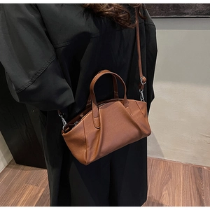 Caramel brown PU leather crossbody bag shown on model for daily style and size perspective