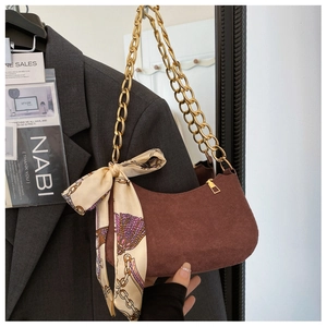 Brown faux suede hobo bag with gold chain strap and decorative floral scarf accessory