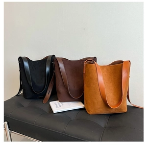 Minimalist suede bucket shoulder bags in black, dark brown, and caramel colors