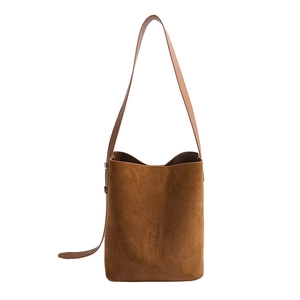 Minimalist brown suede bucket shoulder bag with elegant cylindrical design for women