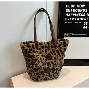 Chic autumn leopard print faux fur tote bag with brown leather handles on white display