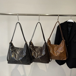 Minimalist PU leather tote bag with asymmetric zippers in black, coffee, and caramel colors