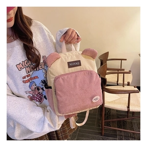 Close-up of corduroy backpack with cute bear ears in pink and beige color blocking