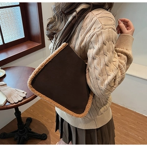 Detail view of brown faux suede shoulder bag with soft beige shearling trim for autumn
