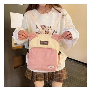 Detail shot of cute velvet backpack with pink and beige patchwork and ear design