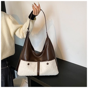 Detail of winter crossbody bag with brown leather and white plush fleece contrast texture