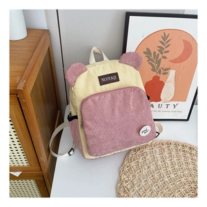 Detail of corduroy backpack showing cute animal ears and texture in soft pink and beige