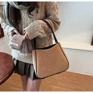 Close-up of camel plush tote bag with black strap and detachable matching coin purse