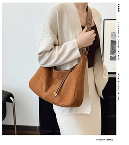 Detail view of large brown hobo bag with suede texture and decorative side knots