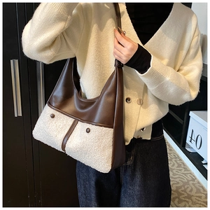 Detail of winter crossbody bag with brown leather and white fuzzy faux fur textures