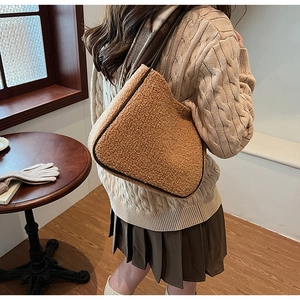 Caramel lamb wool tote bag detail featuring plush texture and dark faux leather piping