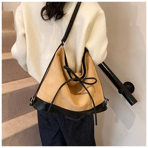 Model view showing the large capacity camel and black tote bag with bow detail