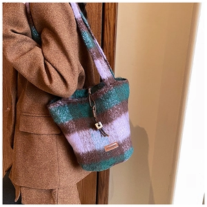 Detail of checkered plaid tote bag showing drawstring closure with wooden bead accent