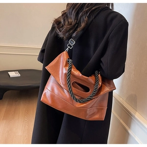 Brown vintage faux leather tote bag with braided handles and adjustable nylon strap