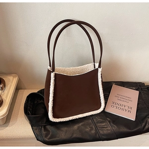 Brown suede tote bag with white faux fur trim and long dark brown shoulder straps