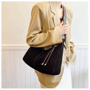 Detail of vintage Hobo bag featuring white contrast stitching and brown leather strap