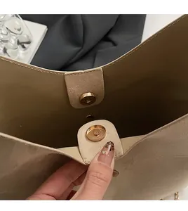 Detail view of the soft PU leather texture and premium gold magnetic closure on handbag