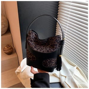 Retro leopard print bucket bag with black leather tassels and gold accents