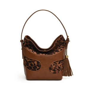 Retro brown leather bucket bag with leopard print accents and decorative tassels