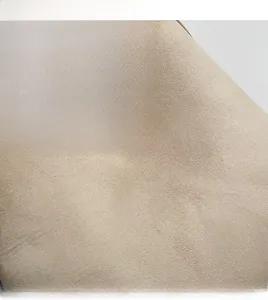 Close-up of soft beige PU leather texture with debossed VEILA logo on fashion handbag