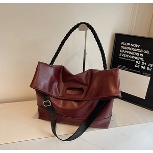 Minimalist burgundy PU leather tote bag with unique black braided handles and wide strap