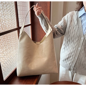 Chic beige soft PU leather large capacity shoulder bag shown in a lifestyle window setting