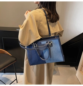Retro denim patchwork tote bag with adjustable shoulder strap worn with a stylish trench coat