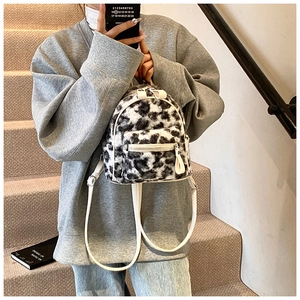 Gros plan d'un mini sac à dos en peluche léopard avec des bretelles en PU blanc