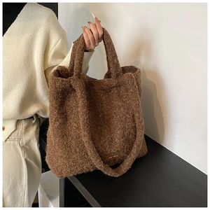 Detail of soft brown sherpa tote bag with our fave fabric label and plush texture