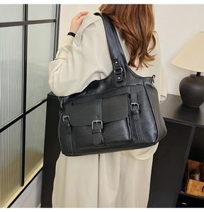 Model wearing a large black matte faux leather tote bag with flap pocket for commuting