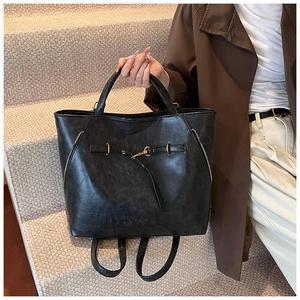 Detail view of retro oiled leather bag showing gold hardware and matte textured surface