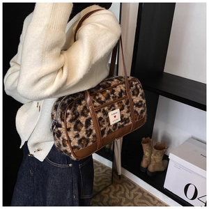 Fashionable leopard print faux fur shoulder bag shown being worn by a model