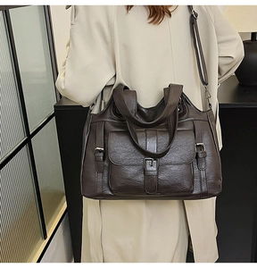 Detailed side view of deep brown large tote bag featuring adjustable strap and front pocket