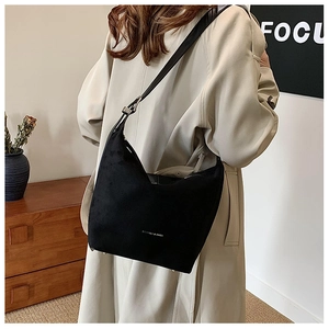 Detail view of large black PU leather hobo bag with adjustable silver buckle strap