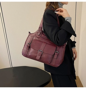 Close-up of a large burgundy PU leather tote bag with vintage texture and shoulder strap