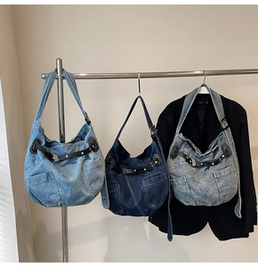Detailed display of vintage denim hobo bags in light blue, dark blue and washed colors