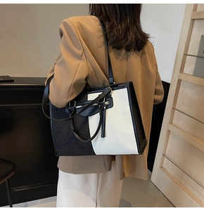 Detail view of large color-block tote bag with zipper pocket and dual carry straps