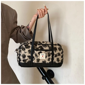 Detail of leopard print plush handbag showing fluffy texture and leather handles