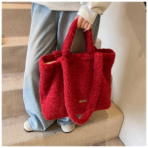 Detail of red plush tote bag with our fave leather label and soft lamb-like texture