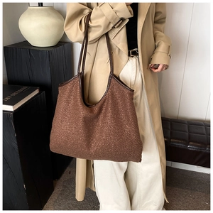 Detail of a large brown faux fur tote bag with thin leather straps for autumn style
