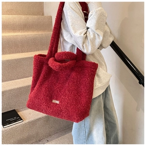 Detail of dark red plush tote bag with our fave label and soft wide shoulder strap