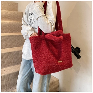 Detail showing the red teddy fleece fabric texture and our fave logo on large tote bag