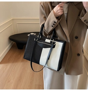 Detailed view of bicolor tote bag with dual straps and functional front zipper pocket