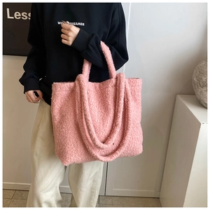 Detail of pink faux fur tote bag showing the soft texture and large shoulder strap design